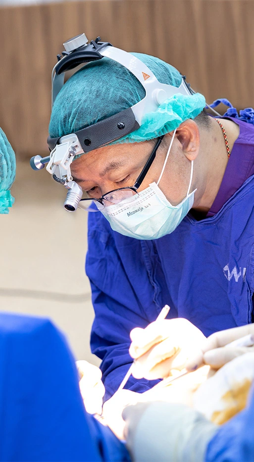 Dr. Chettawut Tulayaphanich performing surgery with a focus and precision.